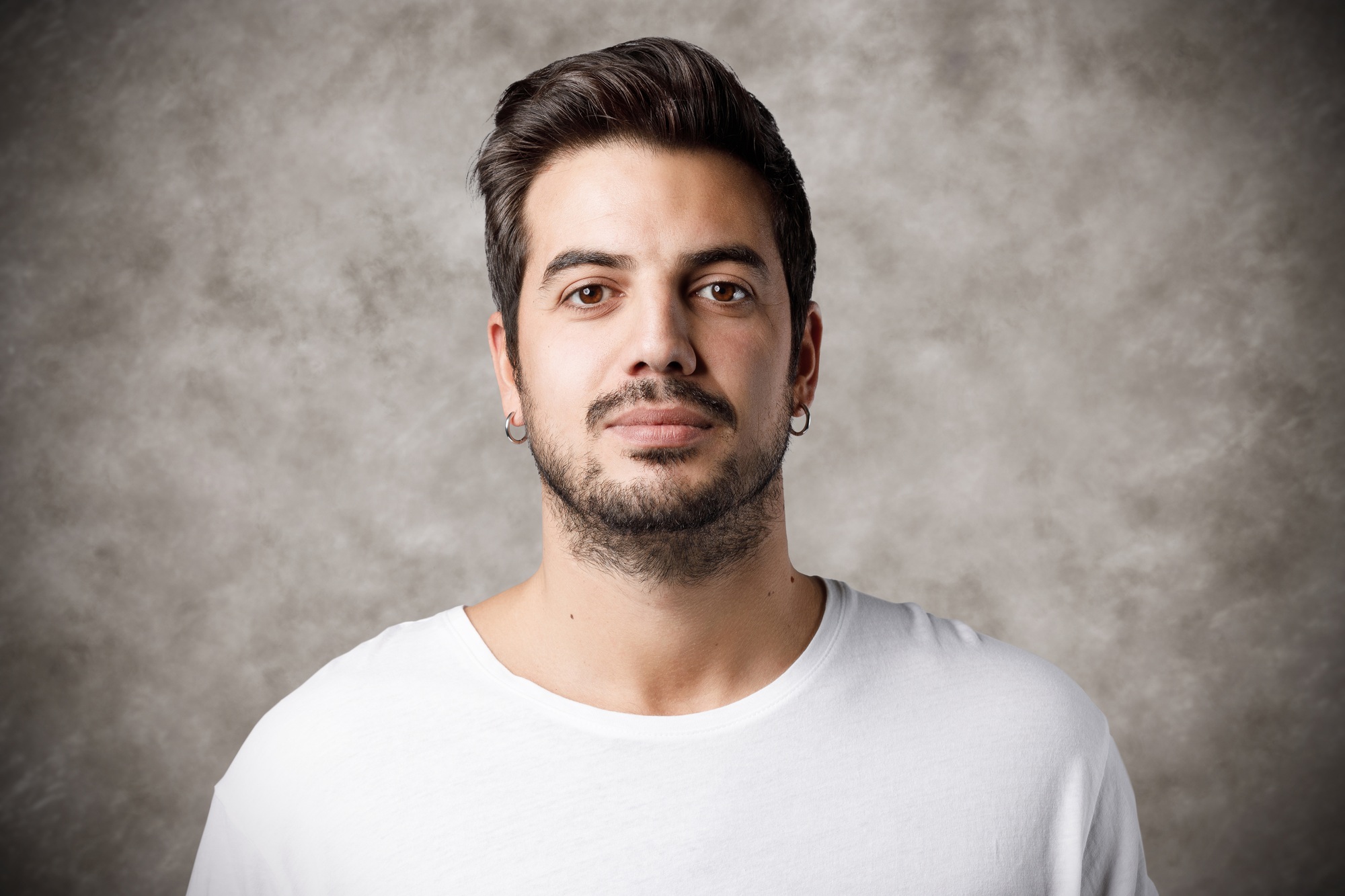 Headshot of young man on grey background
